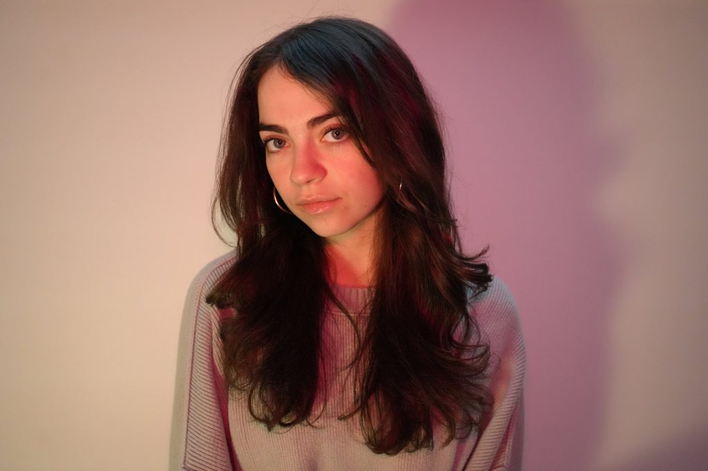 Kaylee Federmann, Tone Talent Agency model, studio headshot in pink sweater